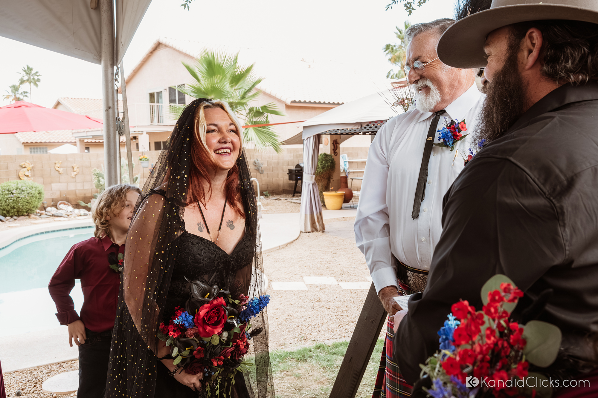 Bride laughing joyfully with groom and officiant during outdoor wedding in Arizona.