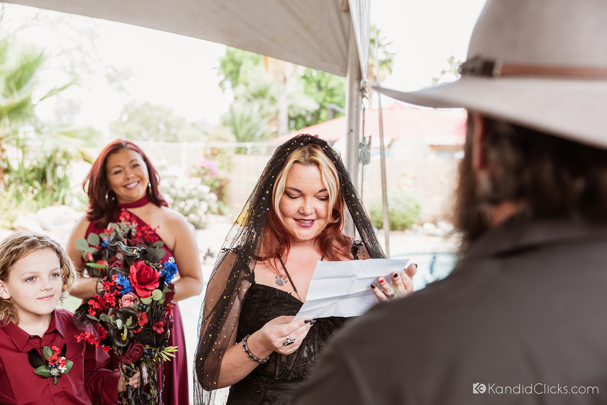 Bride reading heartfelt vows during an outdoor Arizona wedding ceremony.