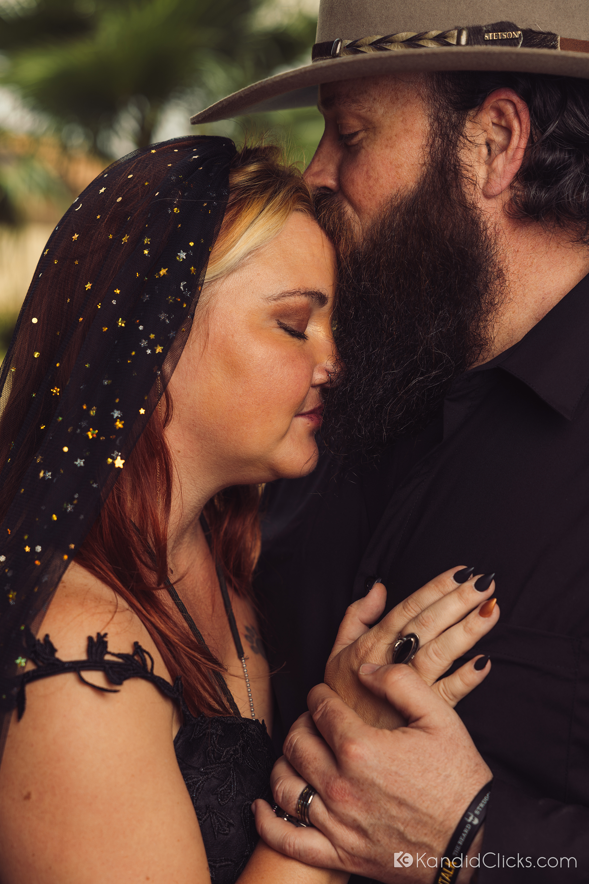 Bride and groom share a quiet, emotional moment in a close embrace.