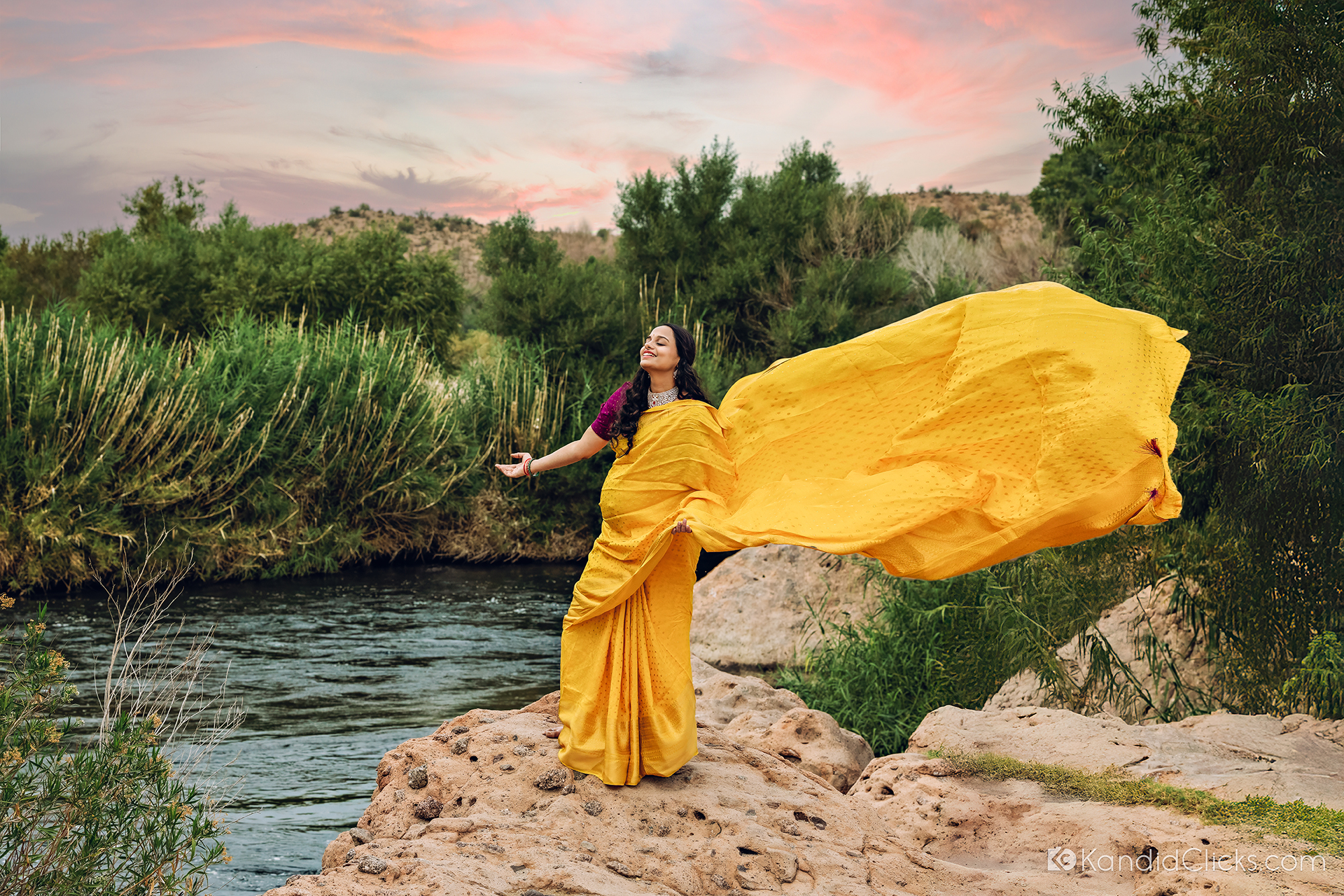Maternity photographer captures vibrant moment of mom-to-be in yellow saree with pallu flying in the wind