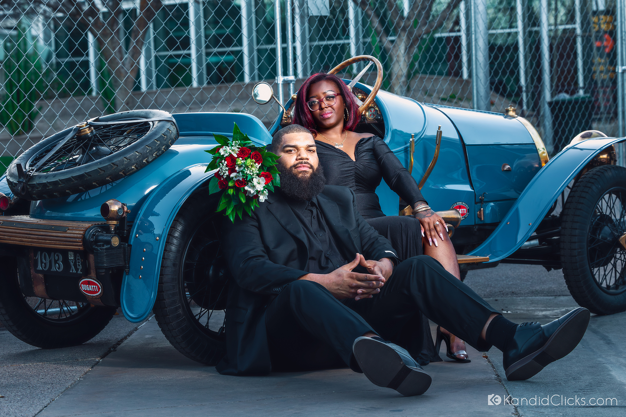 Couple posing with a vintage blue car during their Arizona engagement session.