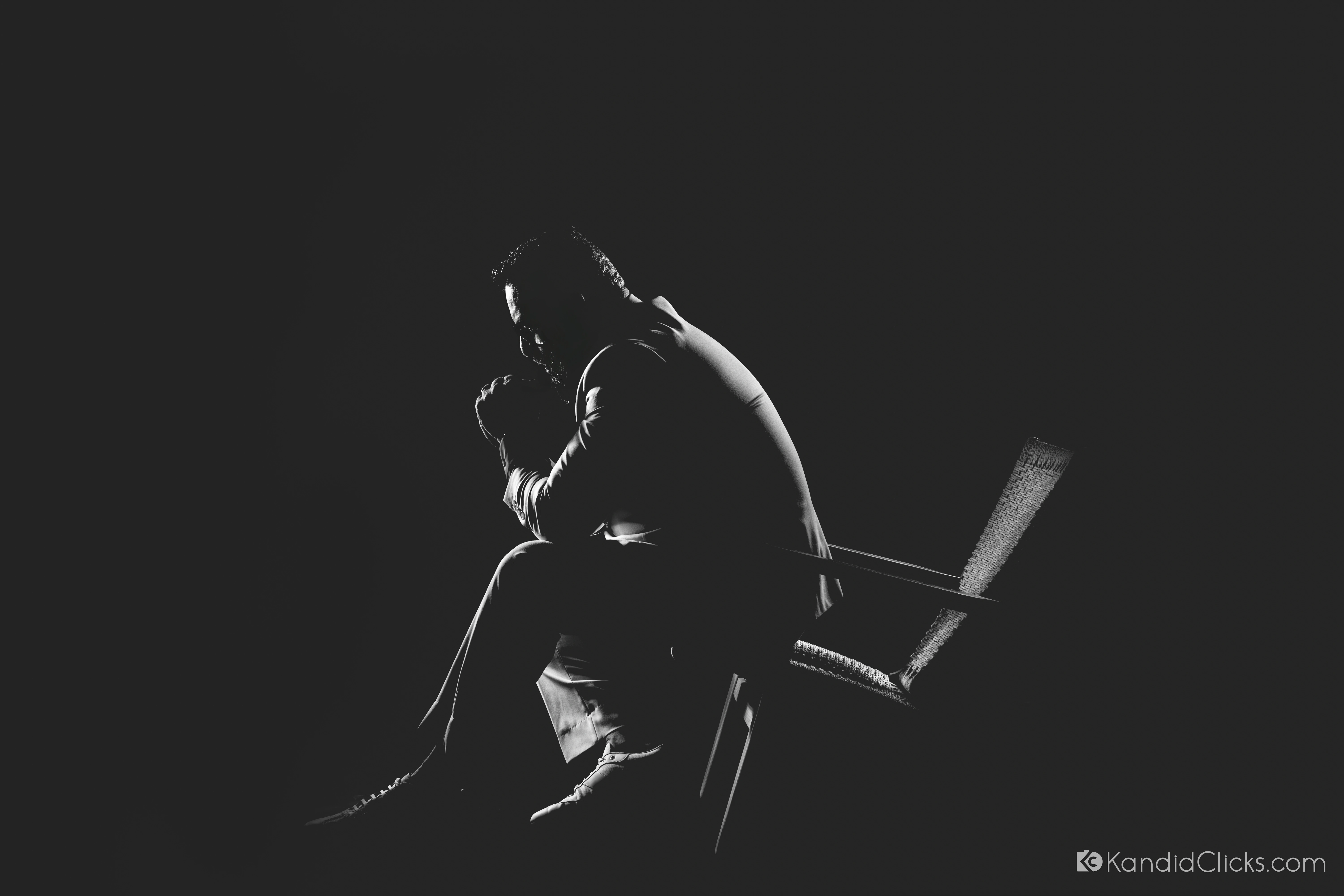 Dramatic black and white couple branding headshot with rim light and shadow silhouette pose.