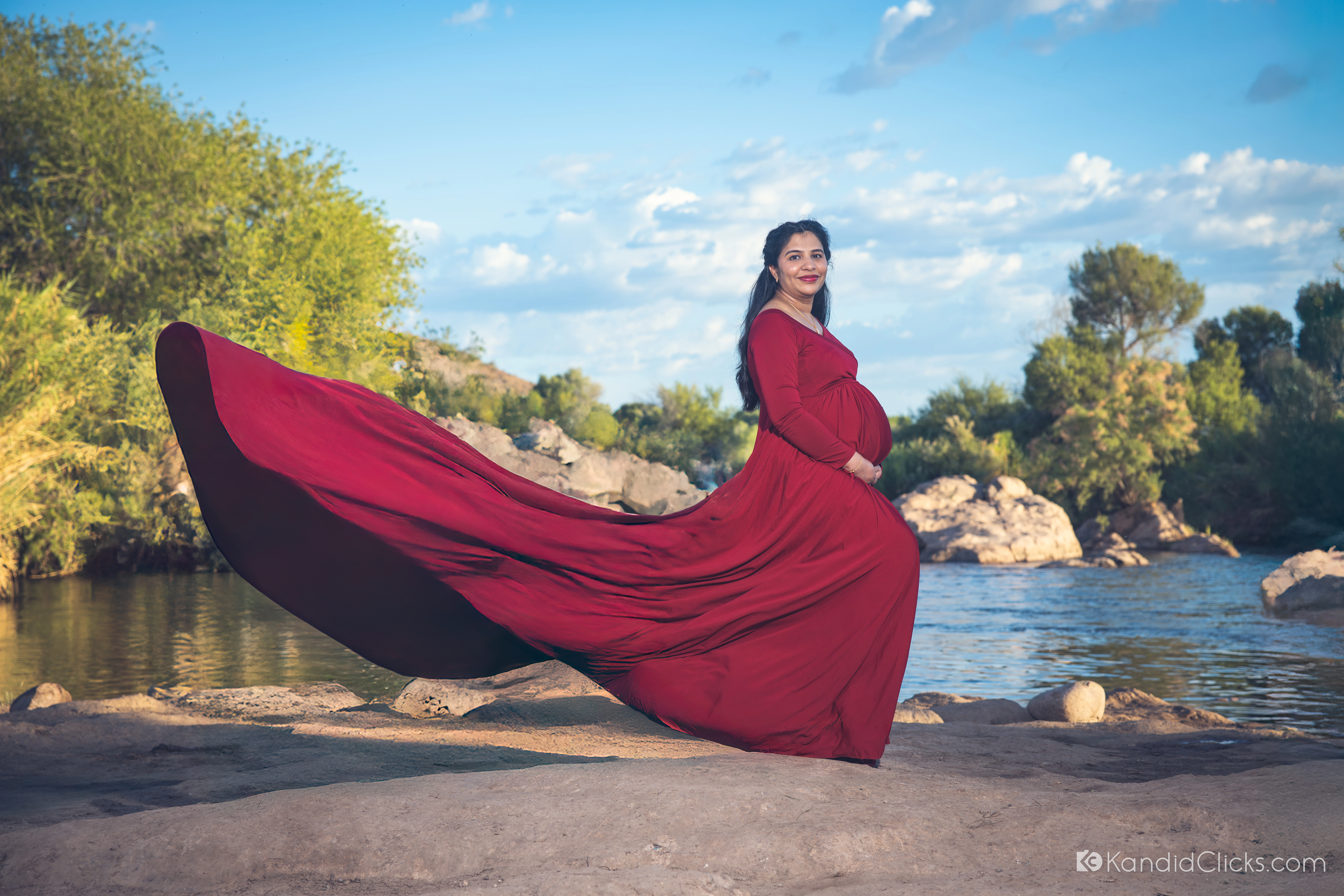 Editorial maternity portrait of Uday's wife in a flowing red gown at Salt River